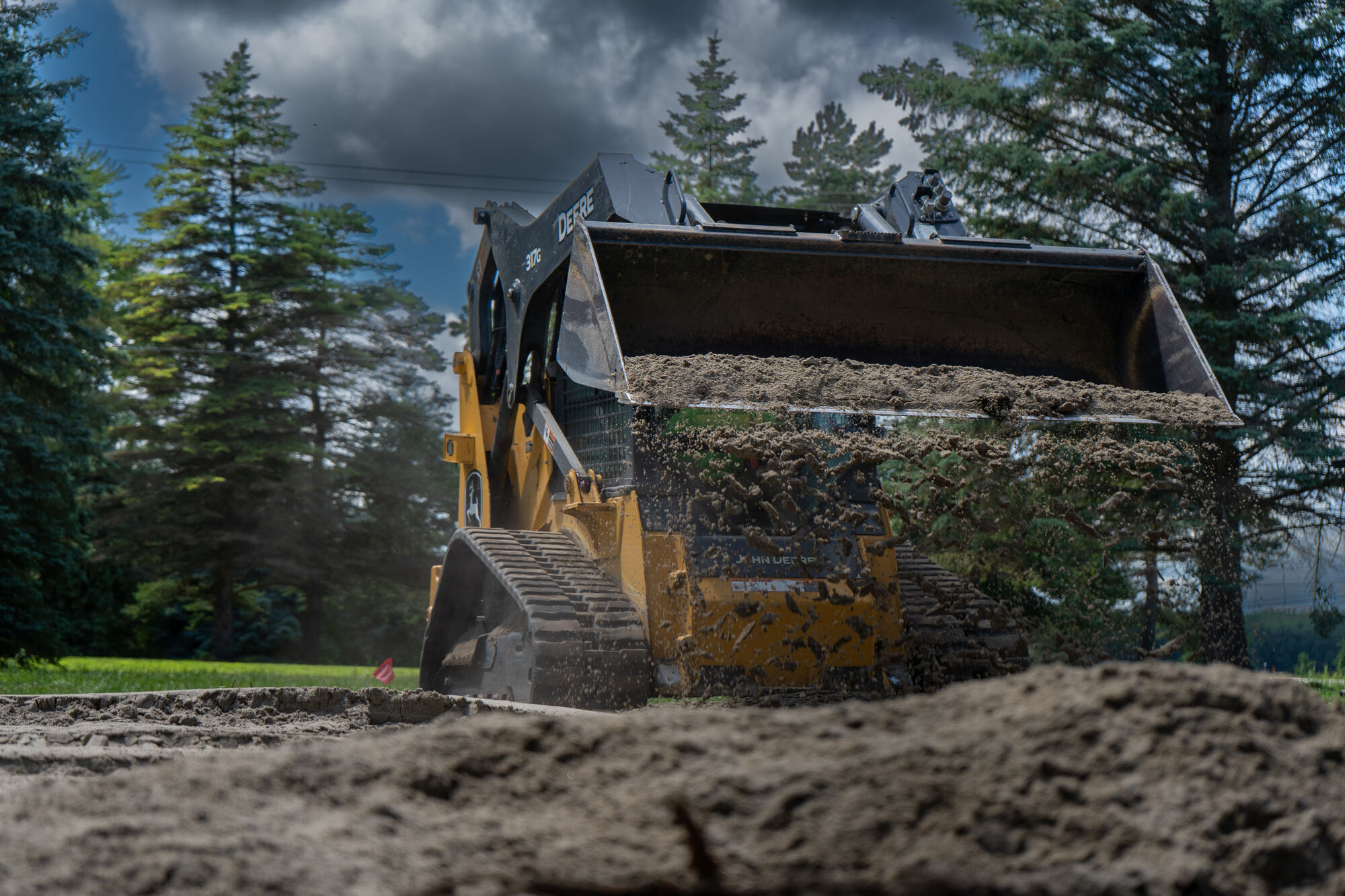 Excavator at work under a dramatic sky, ongoing brand content for a service business